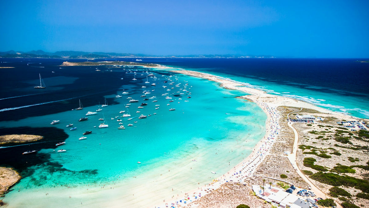 Yachts beside pale sand and turquoise water on the coast of Formentera, Balearic Islands
