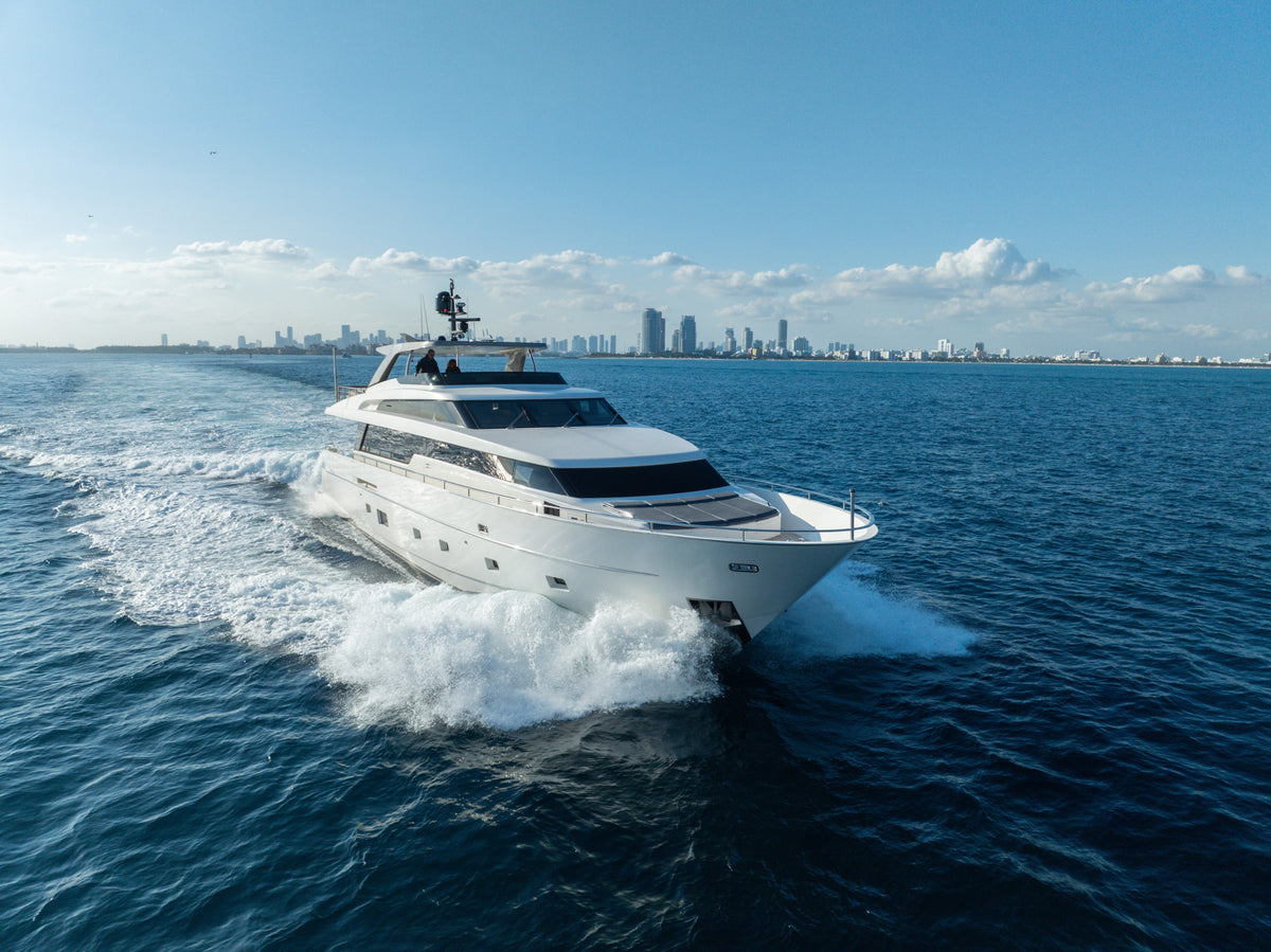 Overhead shot of ASTONISH, a 97ft Sanlorenzo, at rest on turquoise water near a Miami sandbar