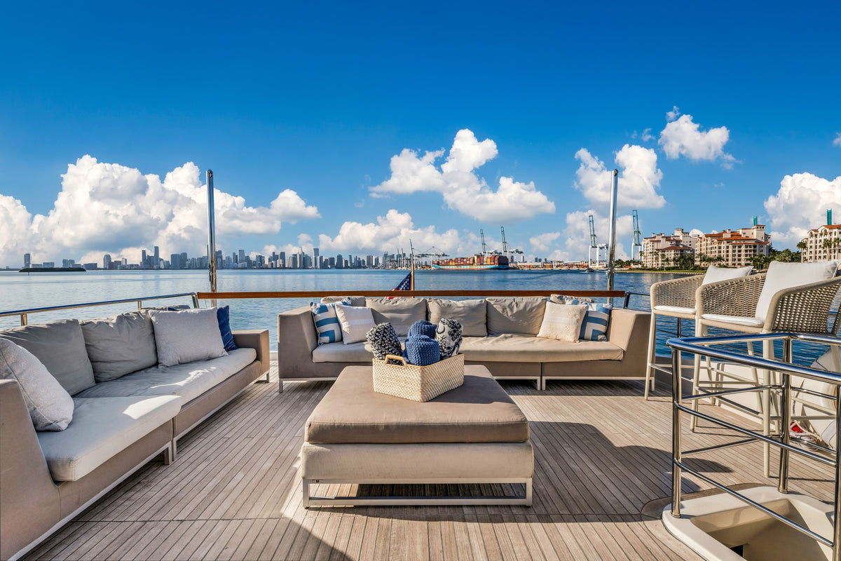 Flybridge lounge aboard ASTONISH, cushioned seating shaded under the hardtop