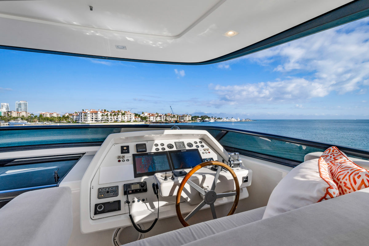 Upper helm station on the flybridge of ASTONISH, twin screens and a leather captain's chair