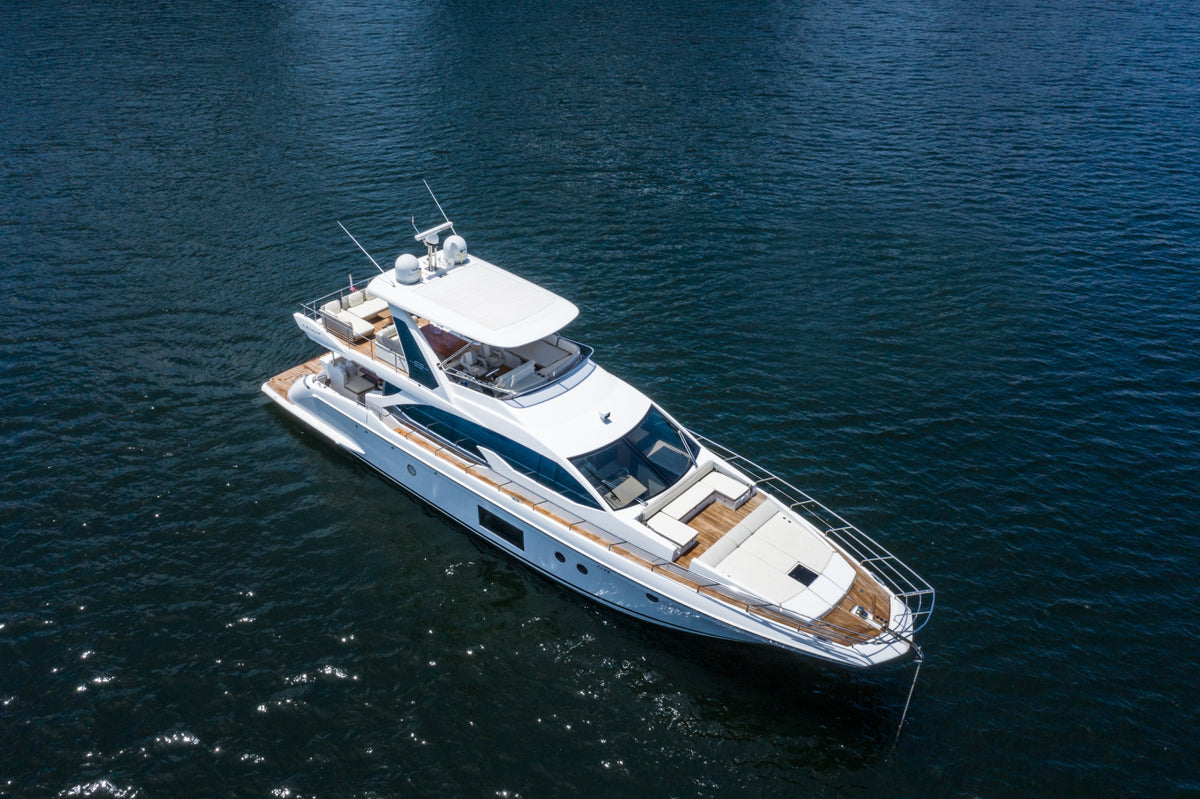 Aerial view of Le Grand Bleu, a 68ft Azimut charter yacht, at anchor in deep blue water