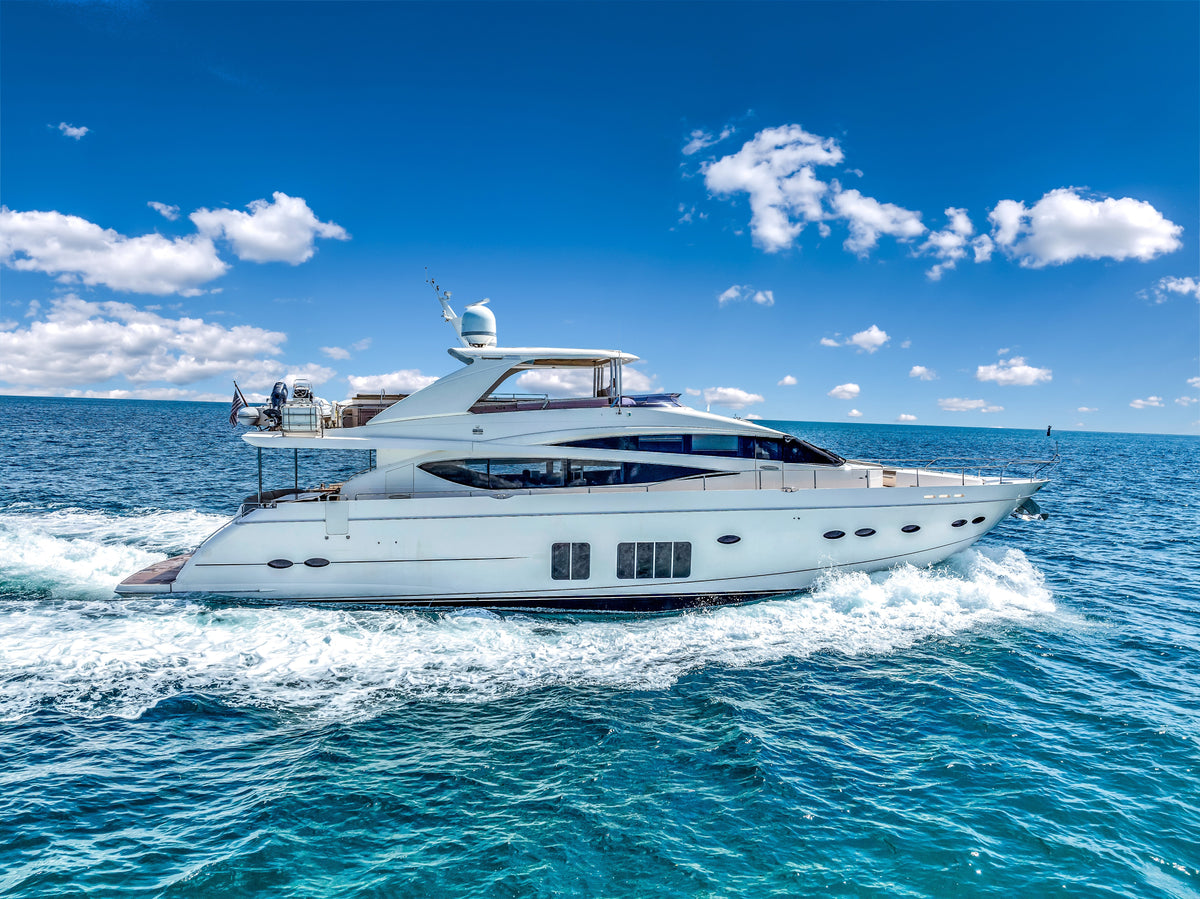 PRAYING FOR OVERTIME, an 88ft Princess, under way on deep blue water, white hull and flybridge hardtop