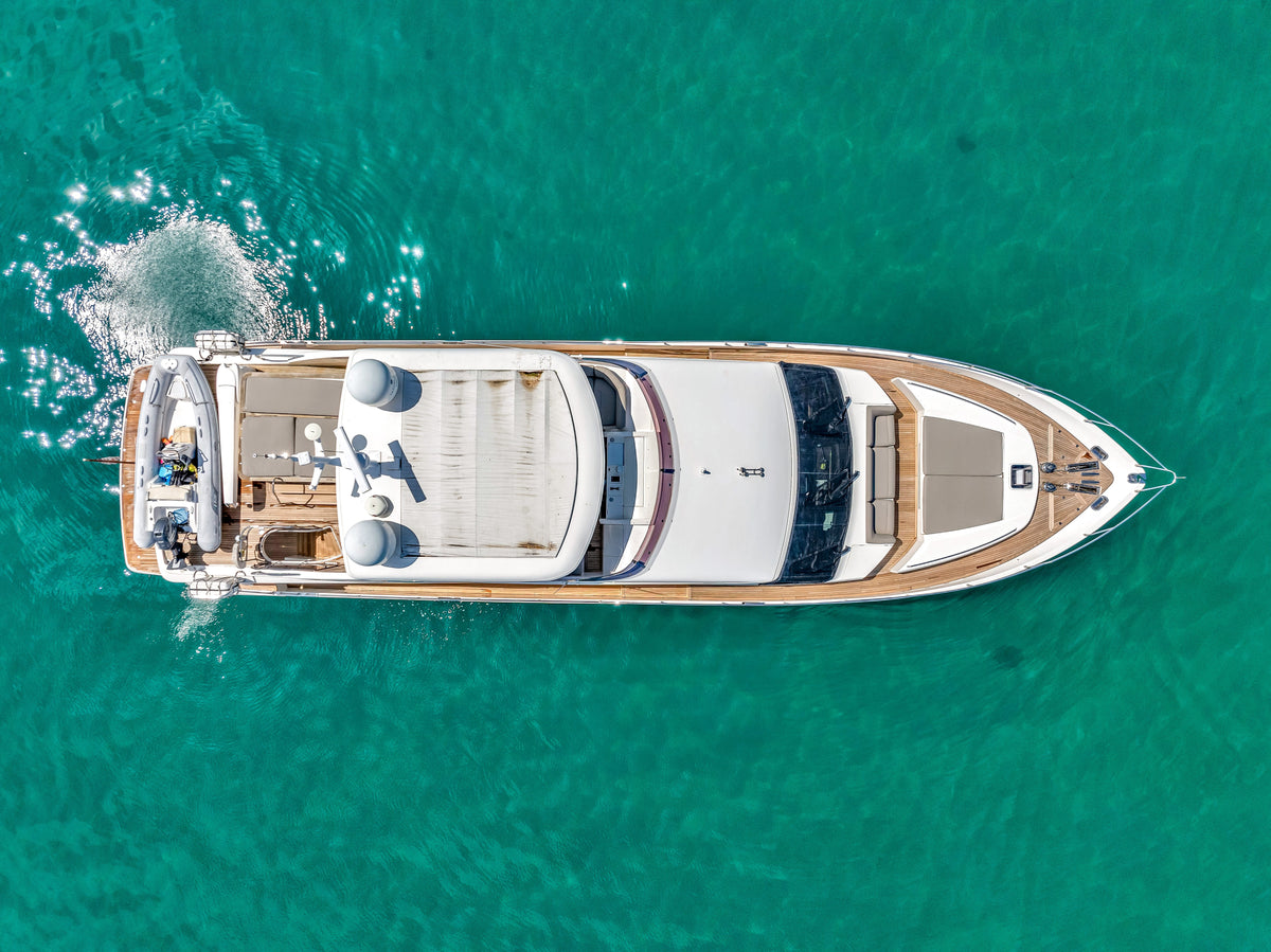 Overhead shot of PRAYING FOR OVERTIME, an 88ft Princess, teak decks, flybridge sunpad and tender aft