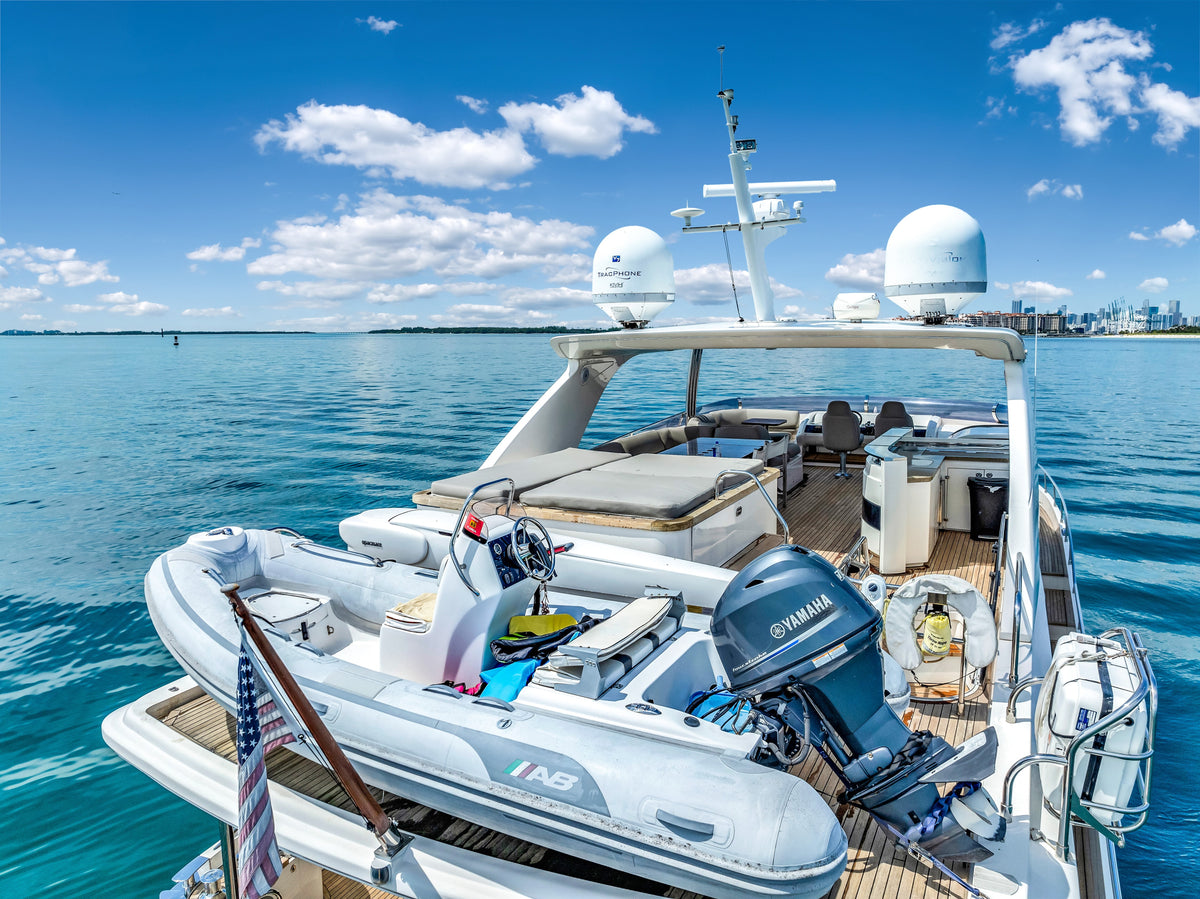 AB tender with a Yamaha outboard on the boat deck of PRAYING FOR OVERTIME, ready for a Miami sandbar day