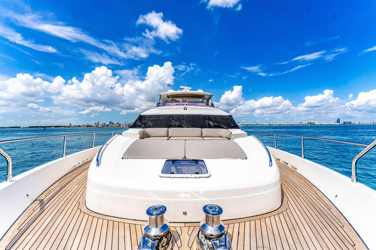 Wide bow sun pad and teak side decks on the 88ft Princess PRAYING FOR OVERTIME, looking aft to the helm