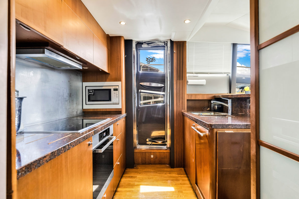 Galley aboard PRAYING FOR OVERTIME with granite counters, cooktop, oven and full-height refrigerator
