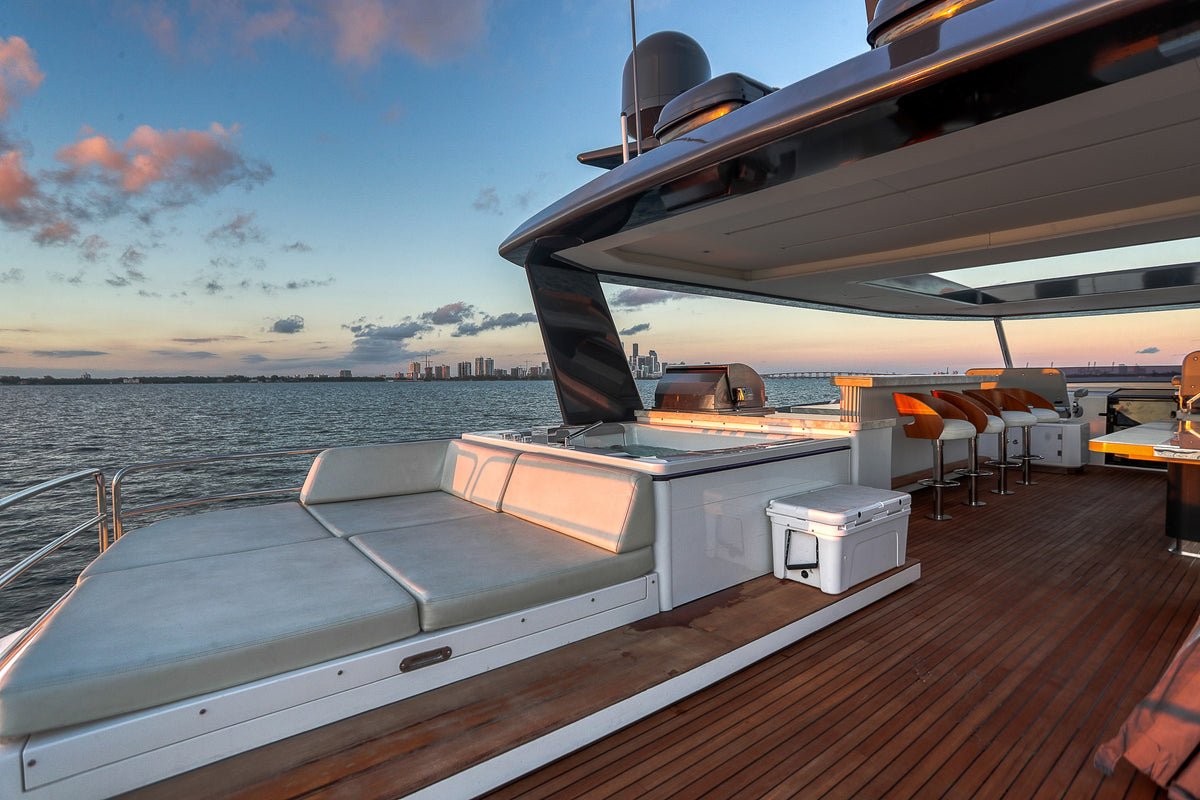 Open sun deck aft on the 88ft Sirena SAINT's flybridge, loungers beside the Jacuzzi