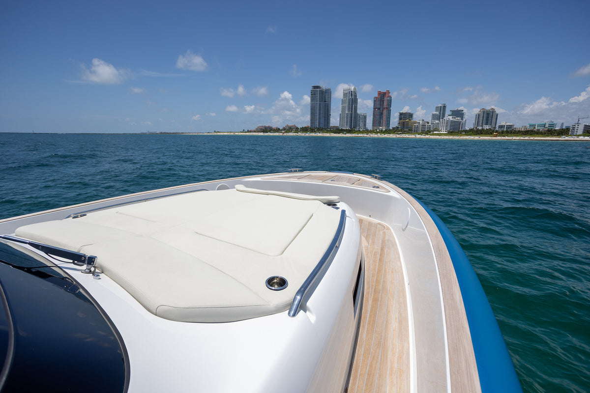 Bow sun pad on the Solaris Power facing the Miami Beach skyline