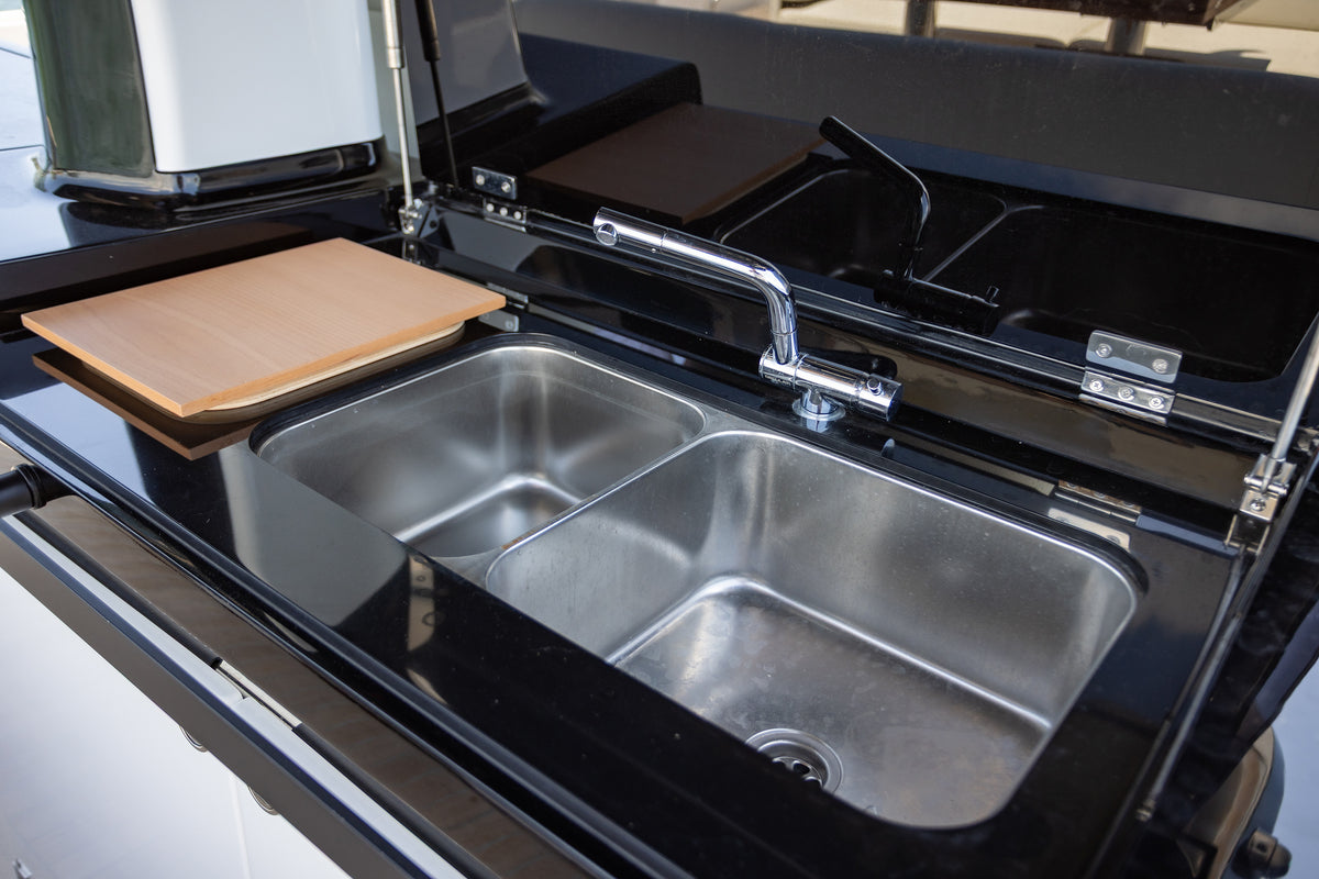 Outdoor galley on the Solaris Power with a double stainless sink and cutting board
