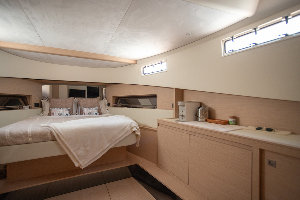 Master cabin on the Solaris Power with light oak joinery and hull windows