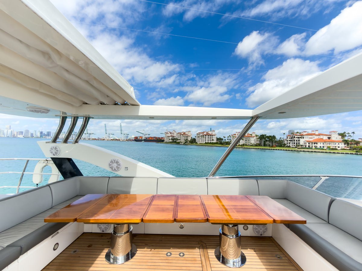 Flybridge dining table and settee under the hardtop on START ME UP