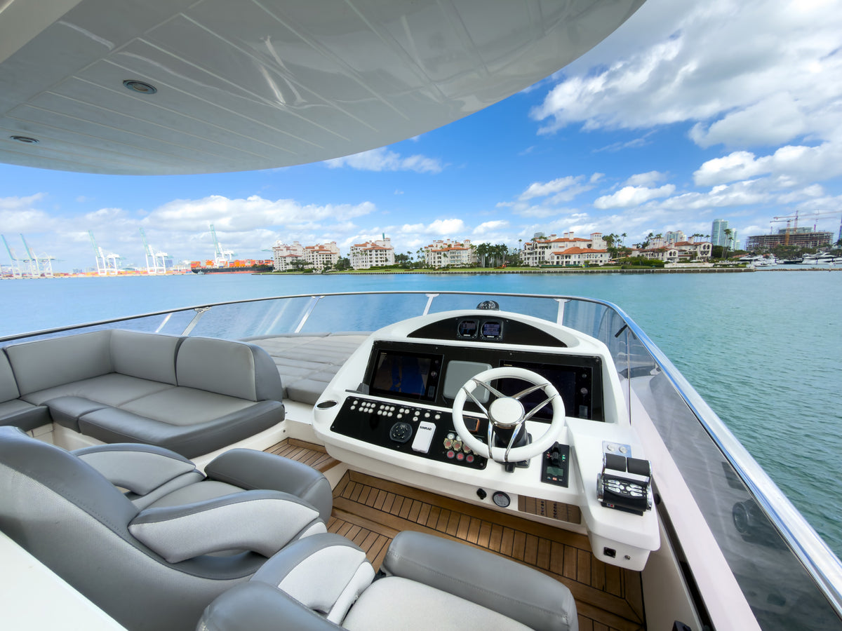 Flybridge helm and companion seating aboard START ME UP in Miami