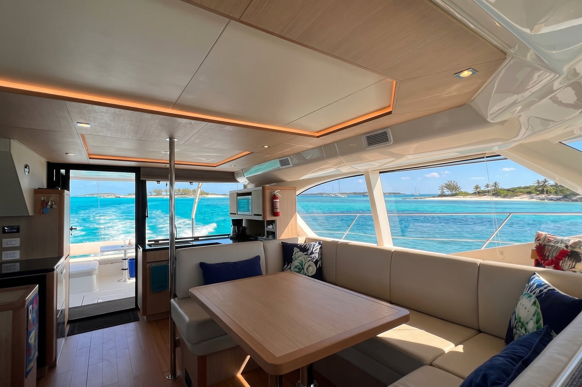 Saloon dinette with wood table and cream seating on Let it be 3, a 44ft Aquila