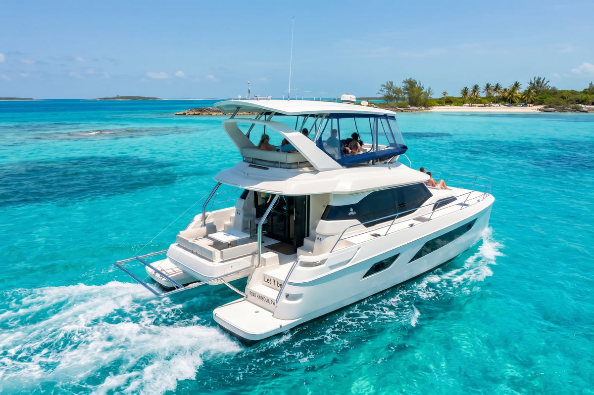 Stern quarter view of Let it be 3, a 44ft Aquila catamaran, with its swim platform and flybridge
