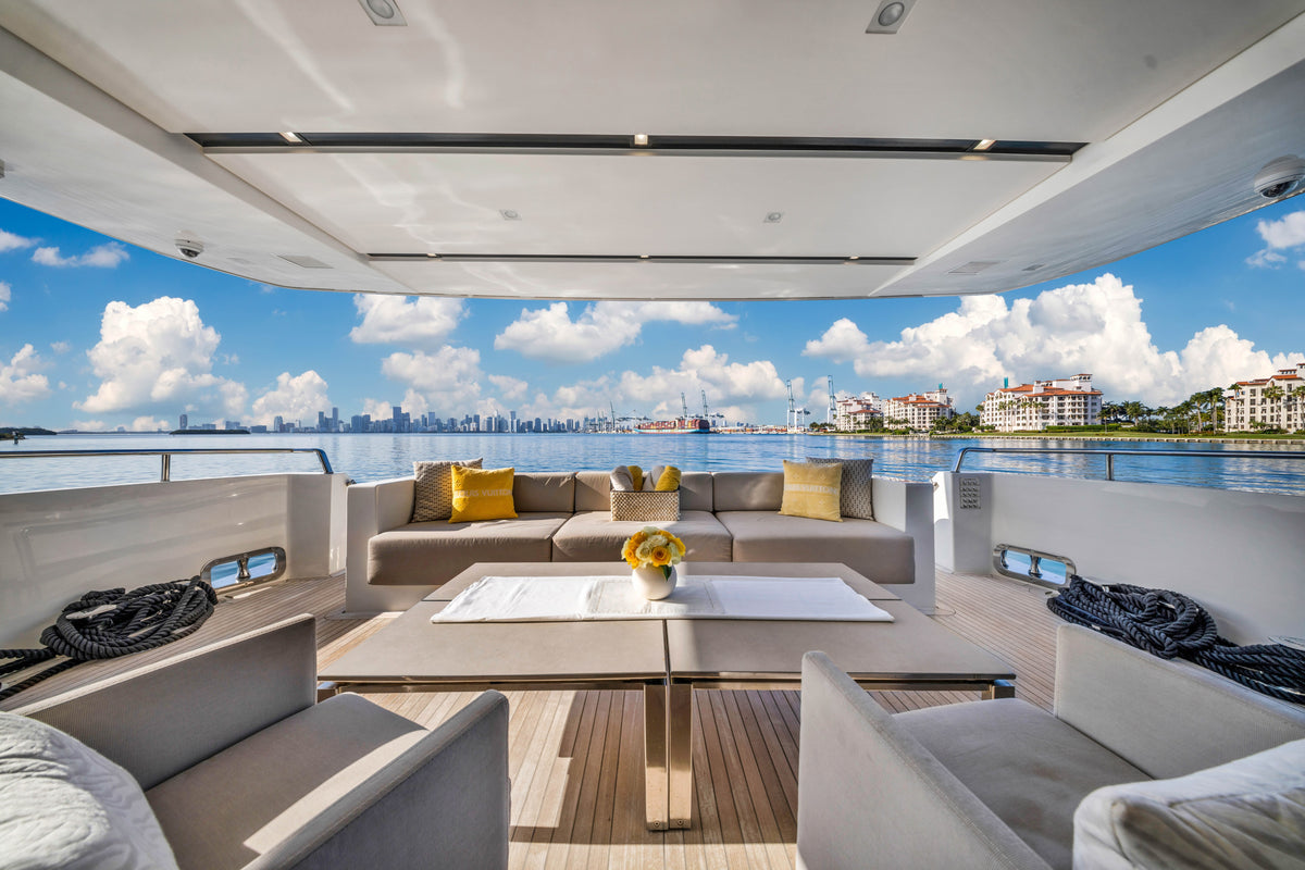 Shaded aft deck of the 97ft Sanlorenzo ASTONISH, dining table and steps to the swim platform in Miami