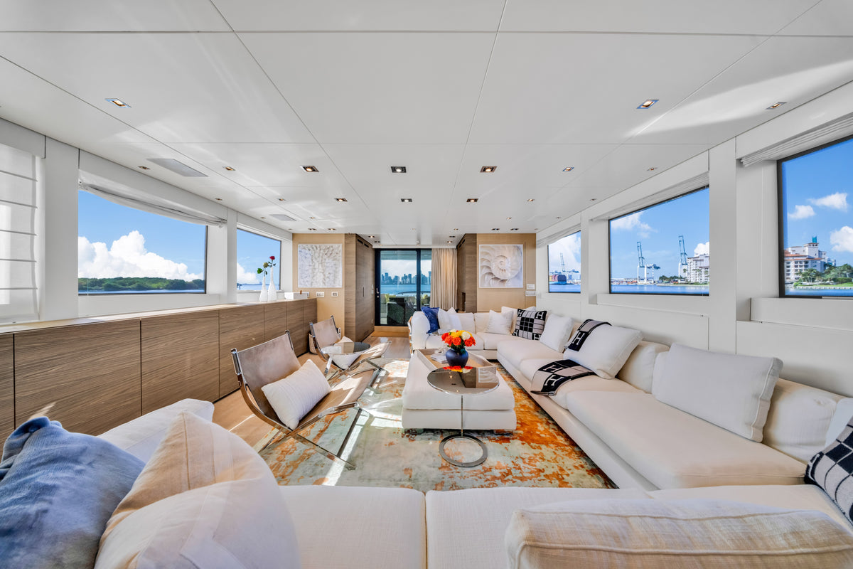 Saloon seating aboard ASTONISH, light sofas facing a low table in a full-beam interior