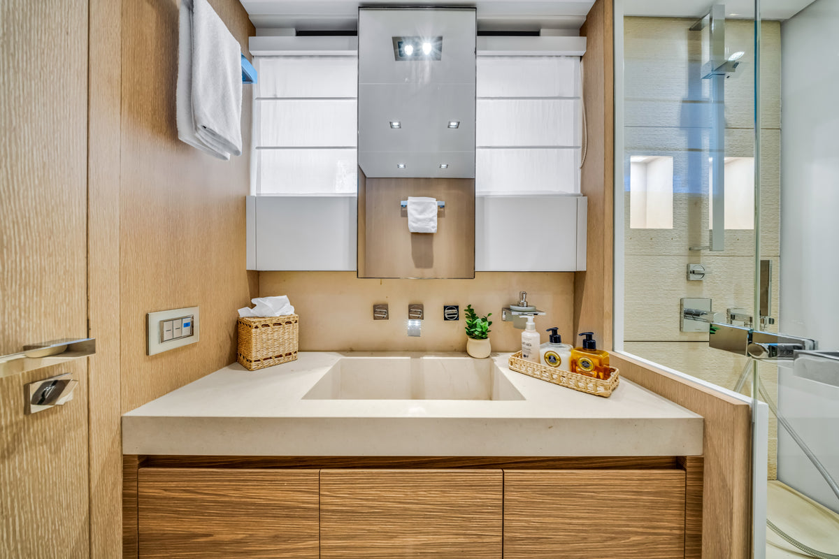 En-suite head aboard ASTONISH, stone vanity, mirror and walk-in shower
