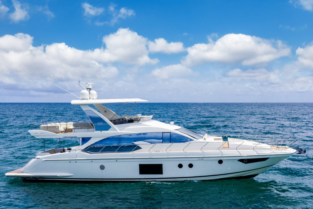 Le Grand Bleu, a 68ft Azimut flybridge yacht, cruising on turquoise water off Miami