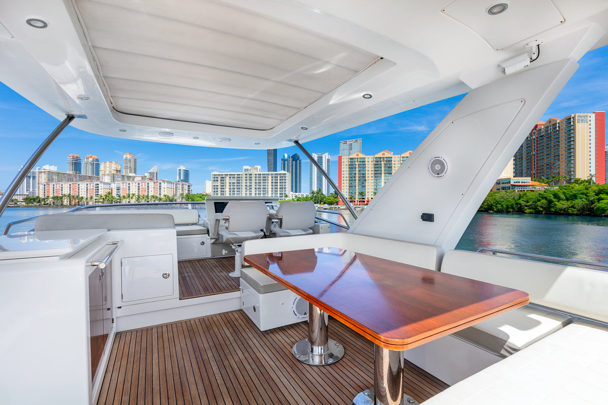 Flybridge dining table and wet bar on Le Grand Bleu, a 68ft Azimut charter yacht in Miami