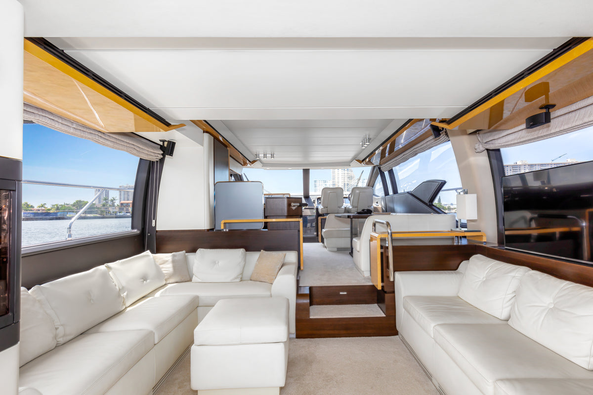 Main saloon on Le Grand Bleu, with white leather sofas and panoramic windows