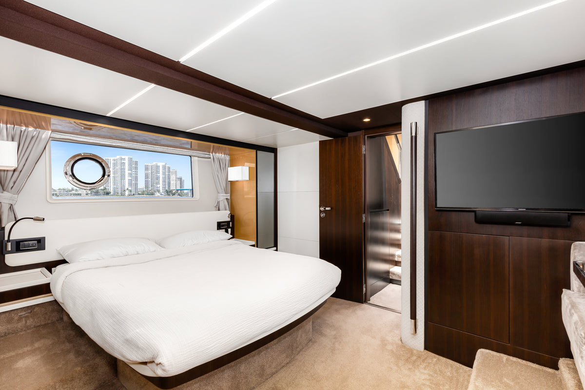 Master cabin on Le Grand Bleu, with a king bed, flat screen TV and natural light