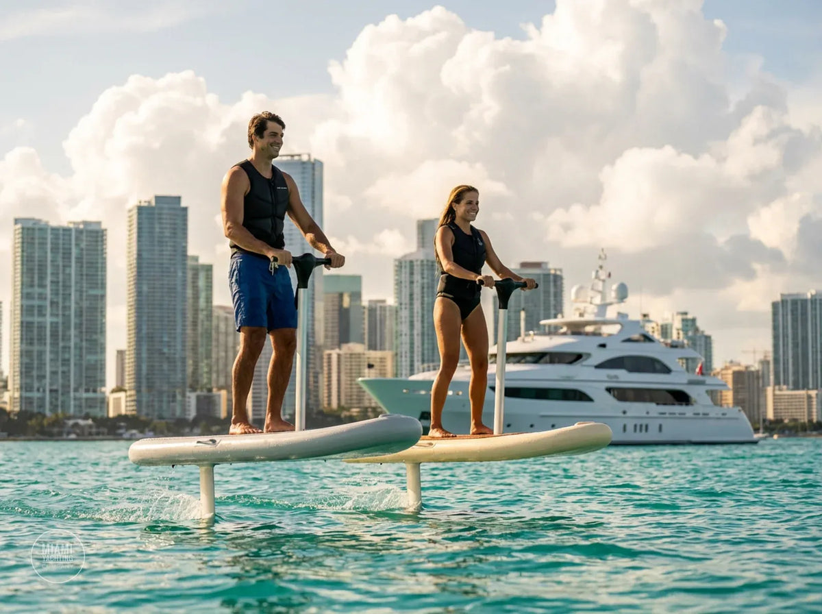 Two riders on Flitescooter electric hydrofoil boards next to a yacht in Miami