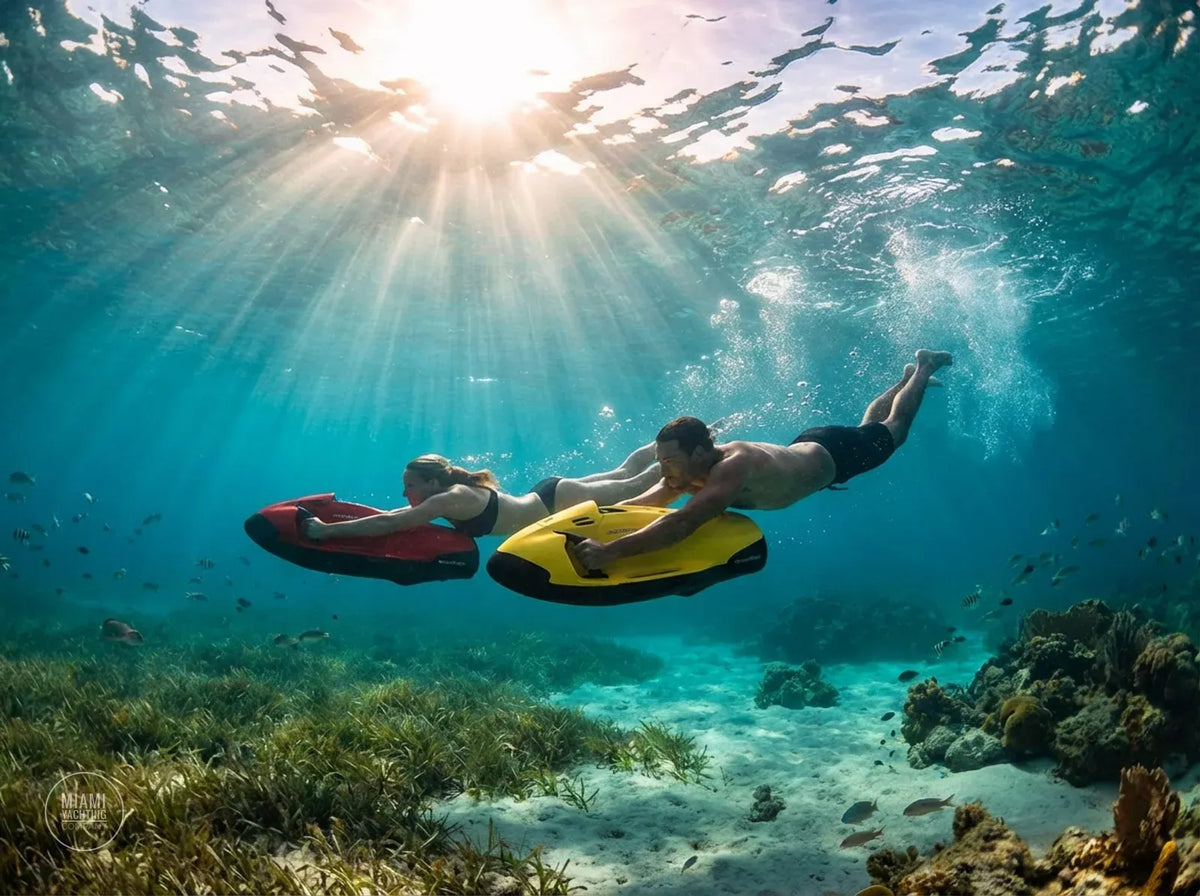 Two swimmers gliding underwater on Seabob sea scooters
