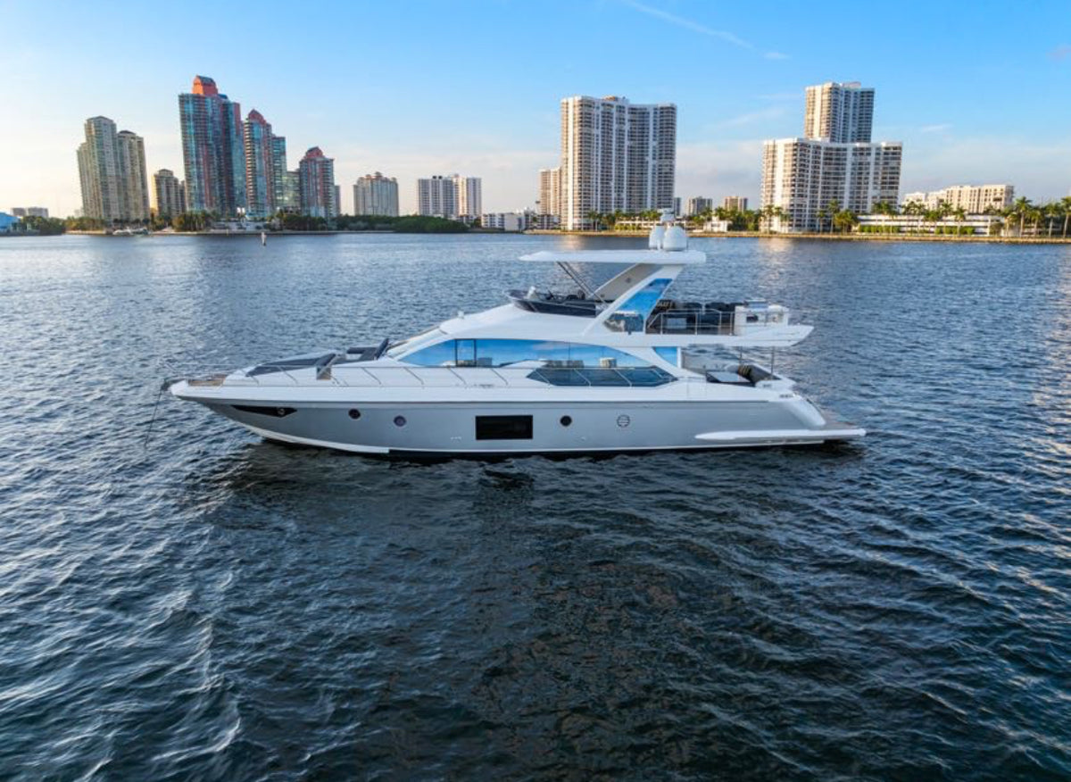 Paragon, a 68ft Azimut Flybridge, in profile on the bay off Sunny Isles Beach