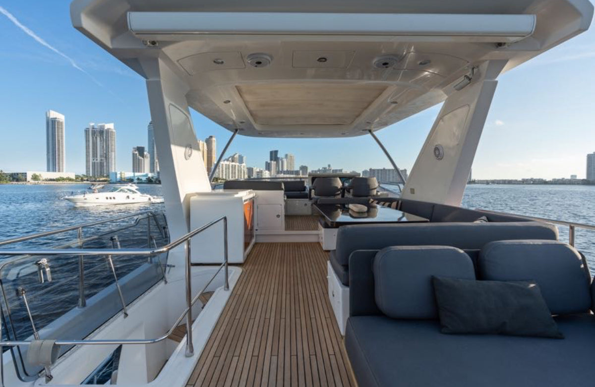 Shaded flybridge lounge on Paragon under the hardtop, with a Miami view