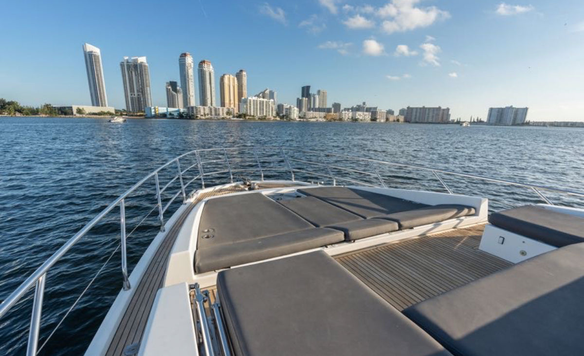Bow lounge and sun pads on Paragon with the Sunny Isles skyline ahead