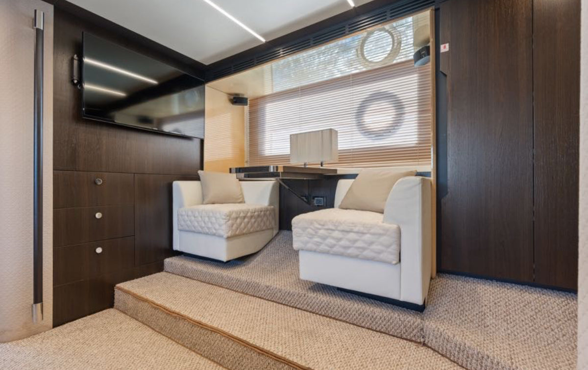 Master suite lounge on Paragon with armchairs, desk and flat-screen TV