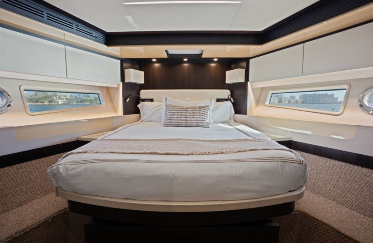 VIP stateroom on Paragon with a centered bed and hull windows on both sides