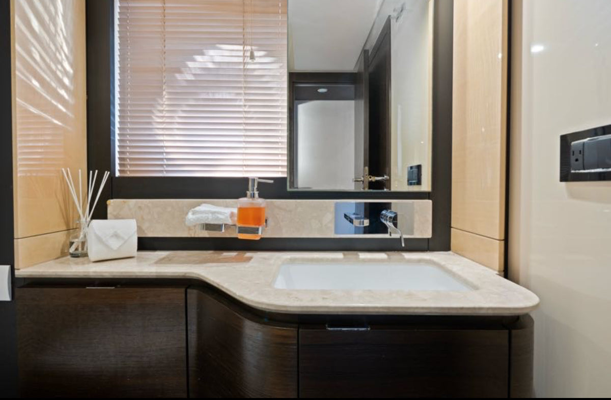 Bathroom on Paragon with a stone vanity, undermount sink and warm wood cabinetry