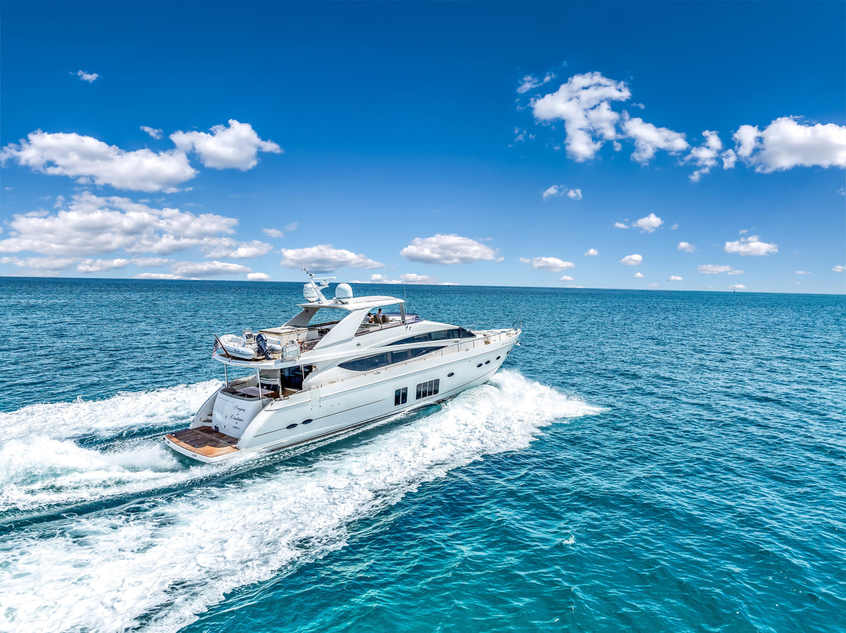 The 88ft Princess PRAYING FOR OVERTIME cutting a wake across open water under a bright blue sky