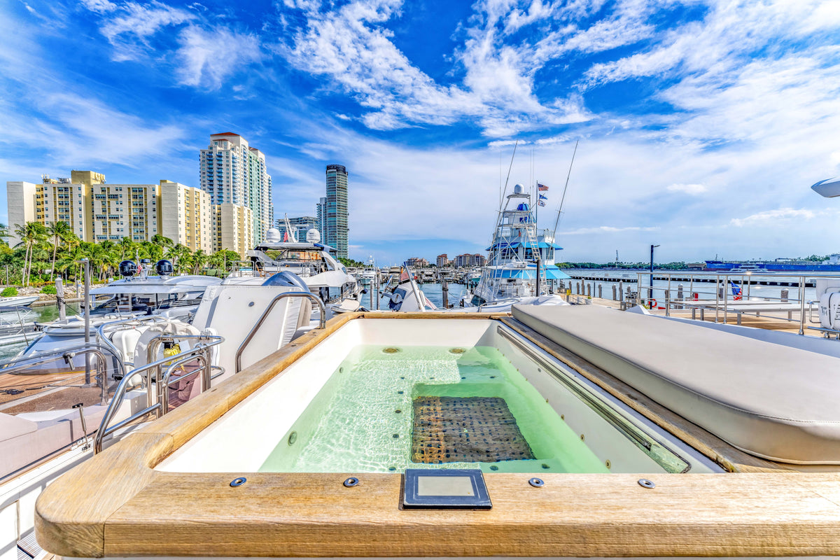 The flybridge Jacuzzi on PRAYING FOR OVERTIME, filled and looking out over the Miami Beach skyline