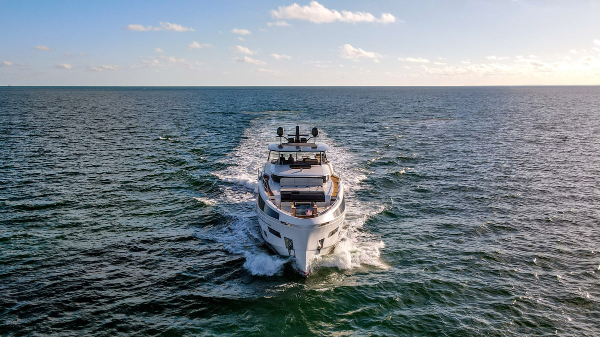 The 88ft Sirena SAINT running offshore, white hull and full flybridge from the air