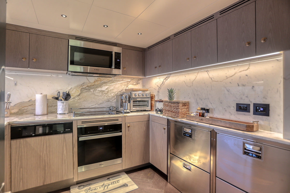 Separate galley aboard SAINT with stone counters and full-size appliances