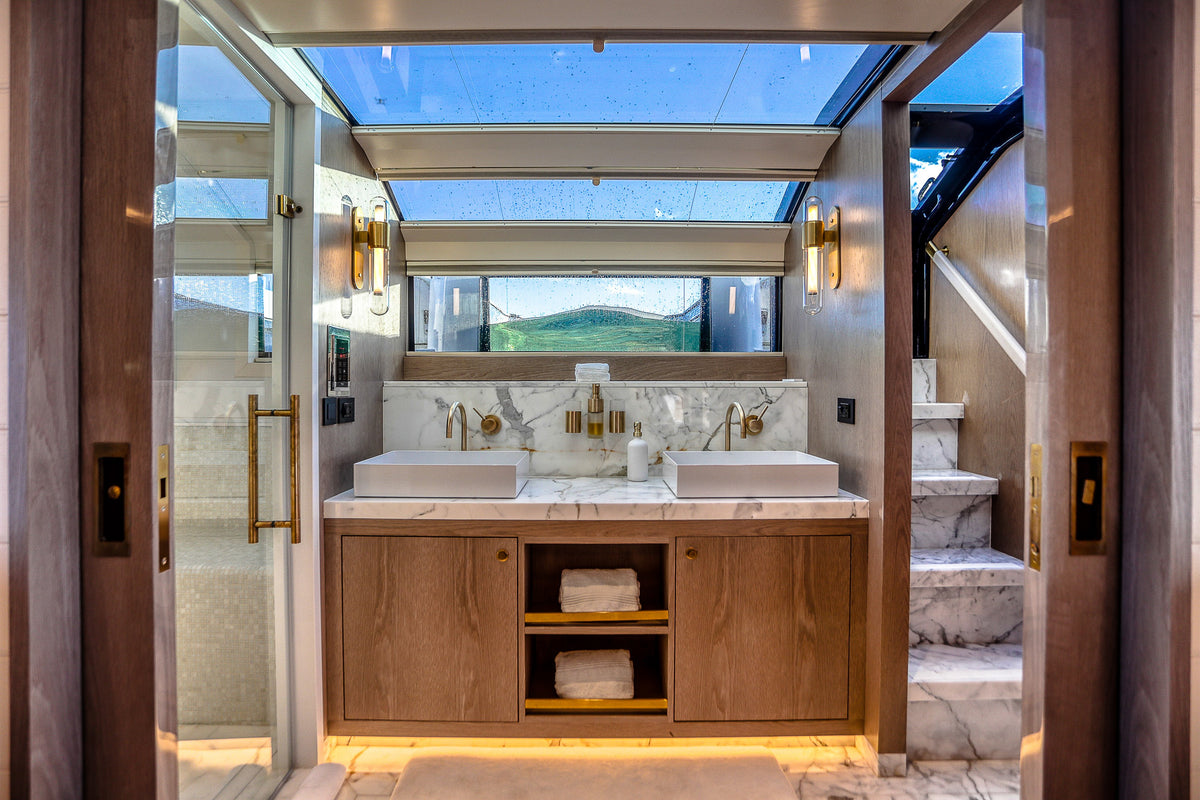 Master bathroom aboard SAINT, marble vanity and walk-in shower