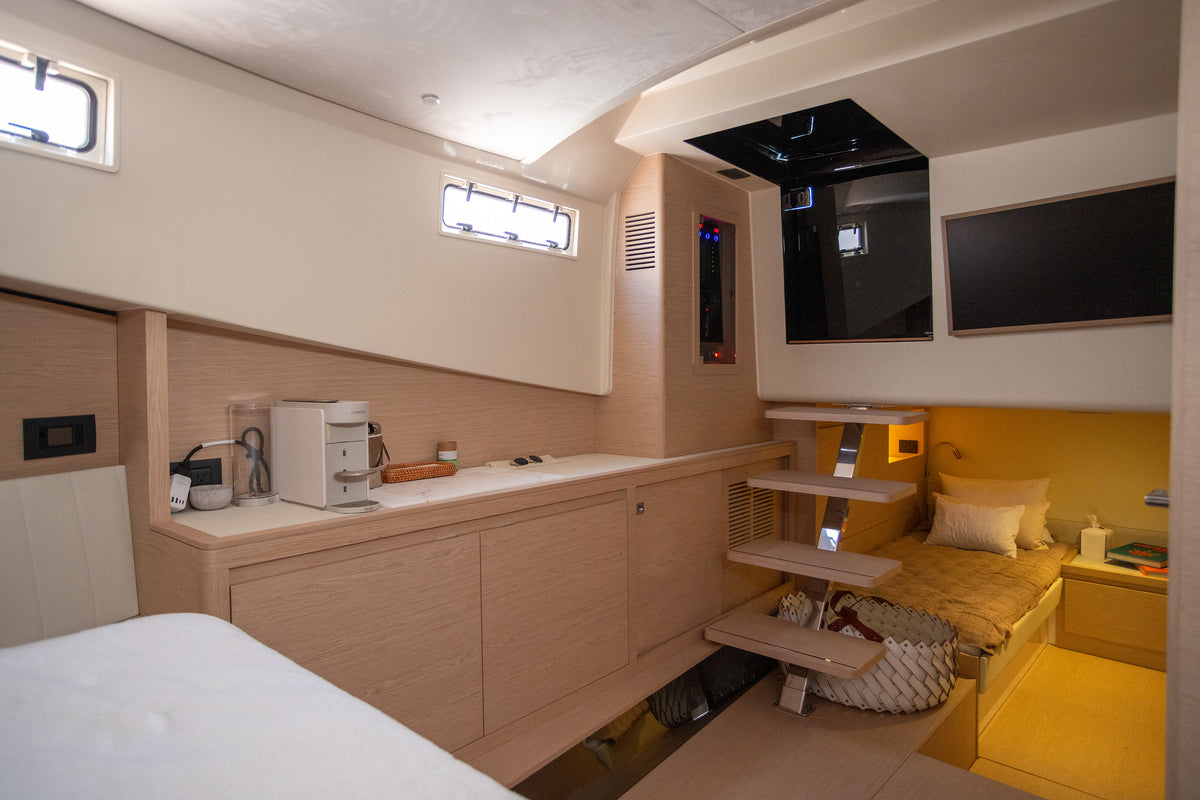 Solaris Power cabin with TV and steps down to the second guest cabin