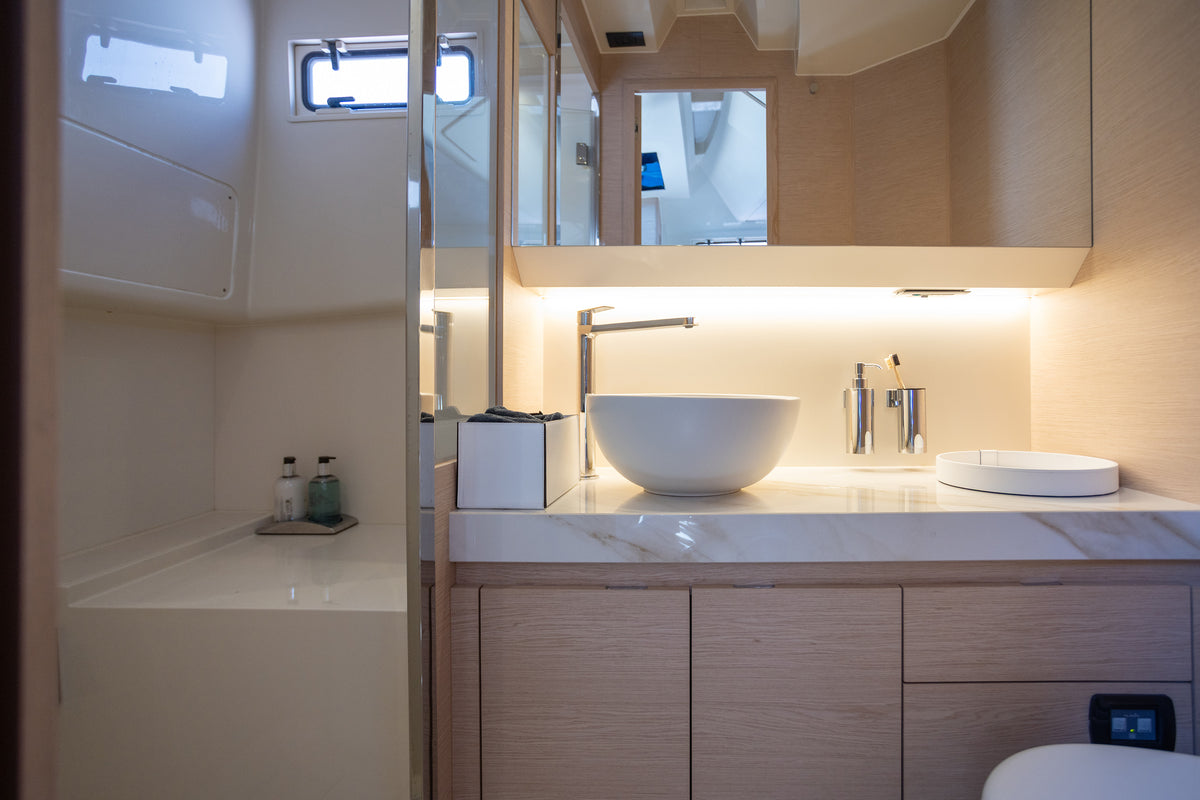 Bathroom on the Solaris Power with vessel sink, stone counter and separate shower