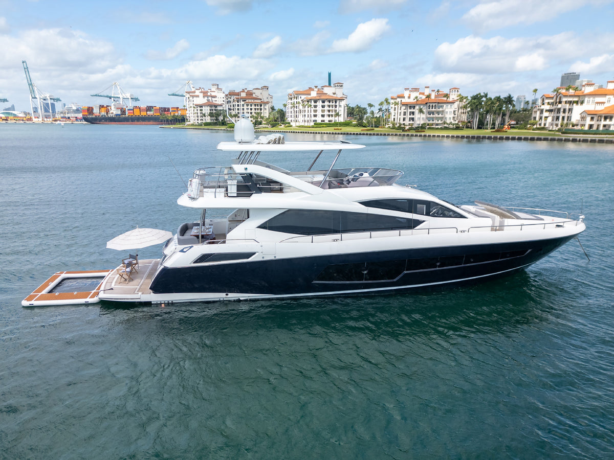 START ME UP, an 80ft Sunseeker flybridge yacht, at anchor with her floating pool off Miami Beach