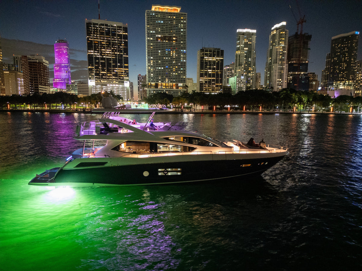 START ME UP lit up at night against the Miami skyline