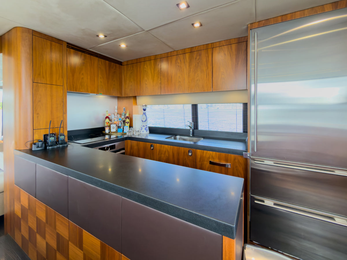 Galley with stone counters and full-size fridge aboard START ME UP