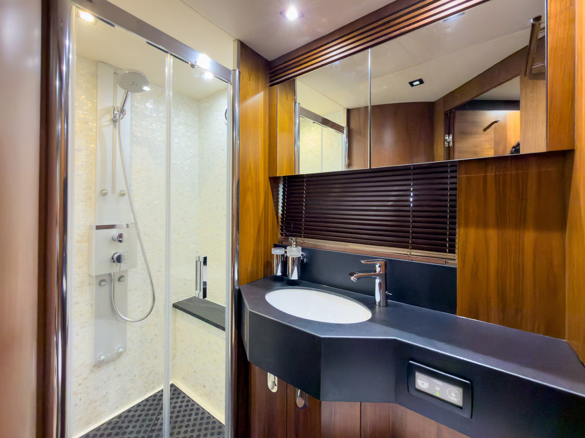 Guest head with glass shower and marble counter aboard START ME UP