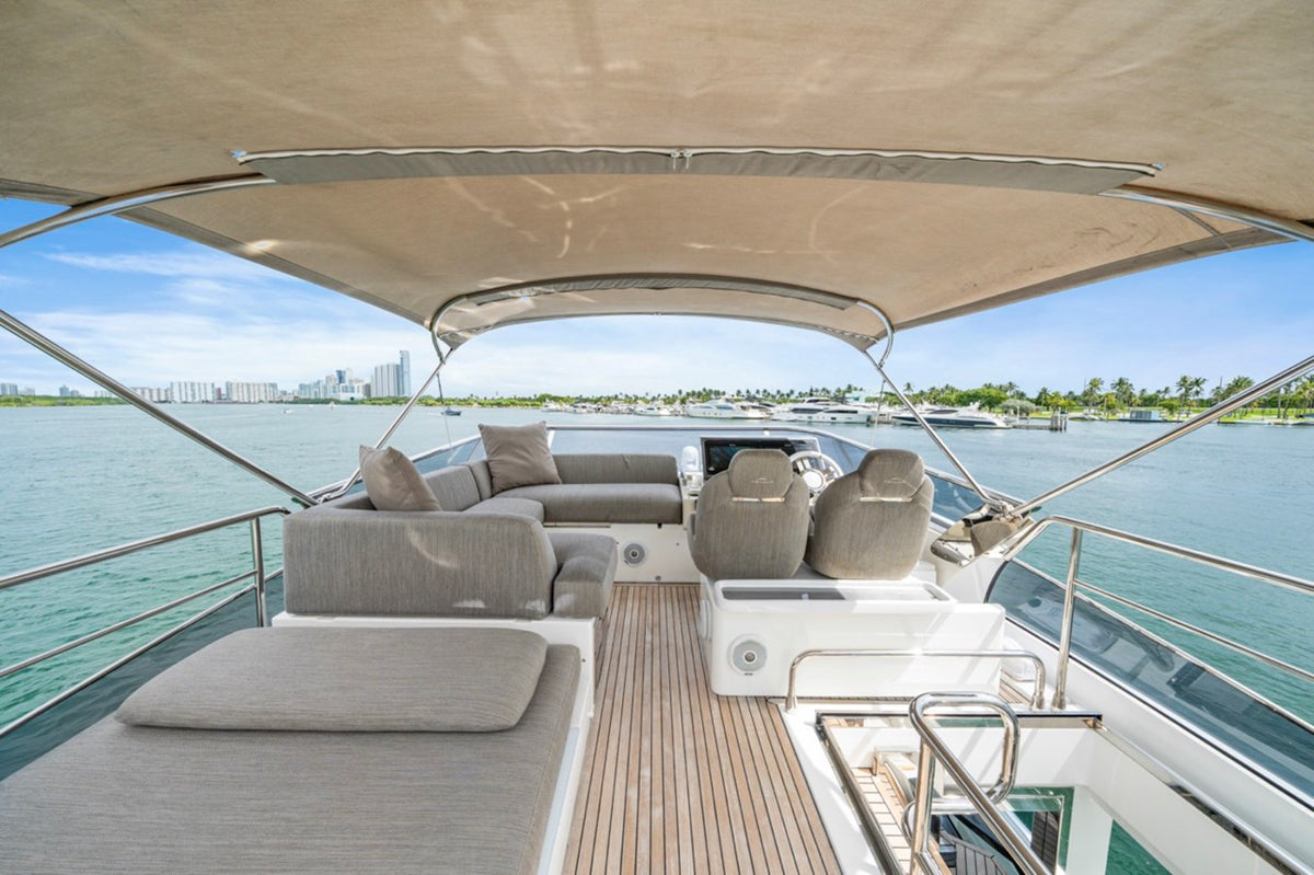 Flybridge on Water You Doing with helm, lounge seating and a bimini top