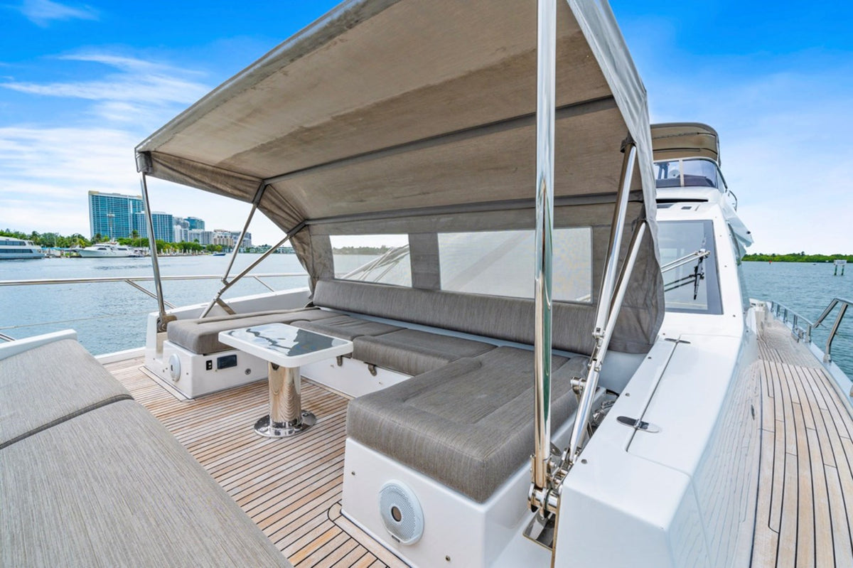 Shaded bow seating and table on Water You Doing under a bimini