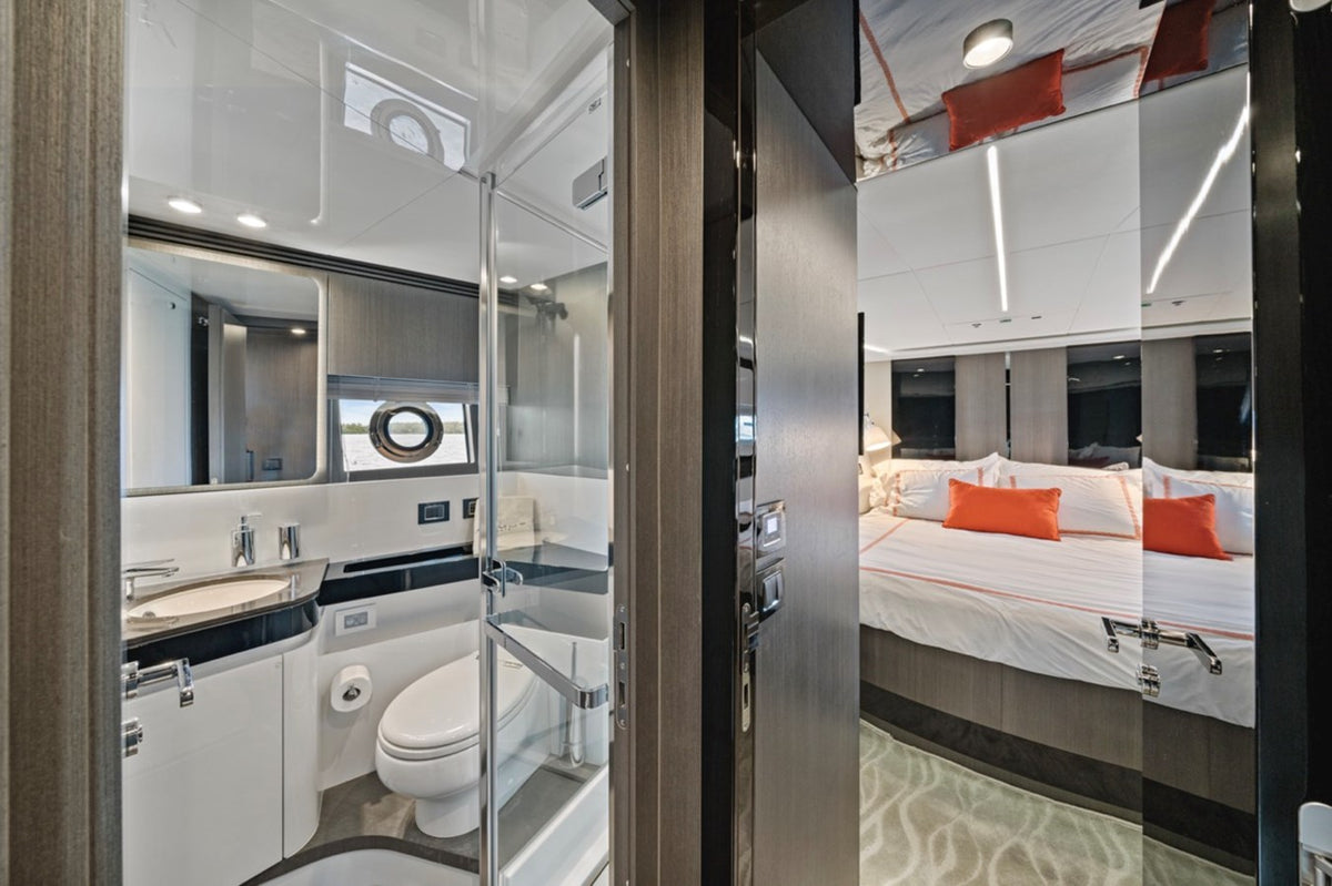 En suite bathroom on Water You Doing opening onto a guest cabin