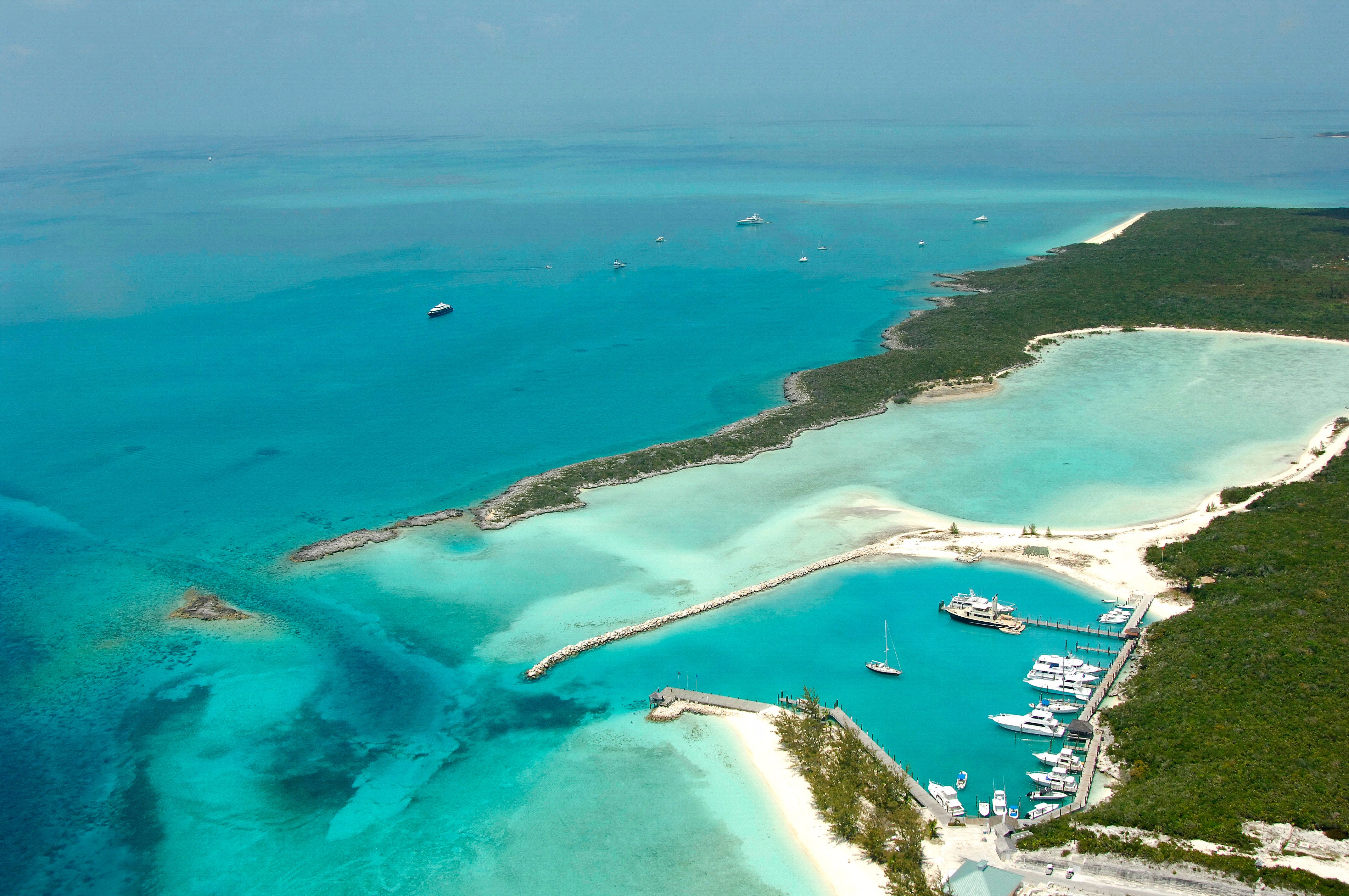 Aerial view of yachts at Highbourne Cay marina, white sand beaches and turquoise water in the Exumas, Bahamas.