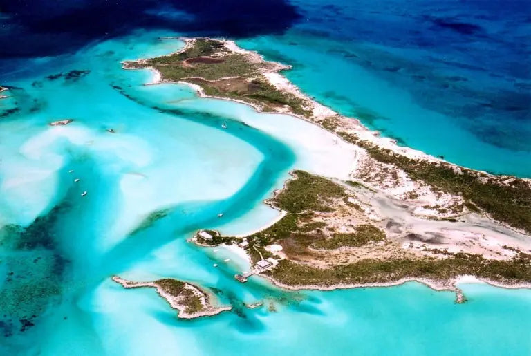 Aerial view of sailboats in the turquoise anchorage beside Warderick Wells Cay in the Exumas, Bahamas.